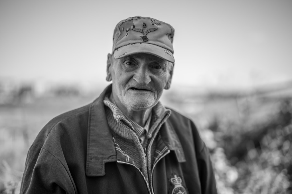 Leica M11 Monochrom outdoor portrait sample image, elderly man in a camouflage pattern hat