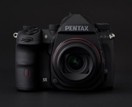 Pentax K-3 III Monochrome against a black background front view, Pentax monochrome DSLR for black and white photography video