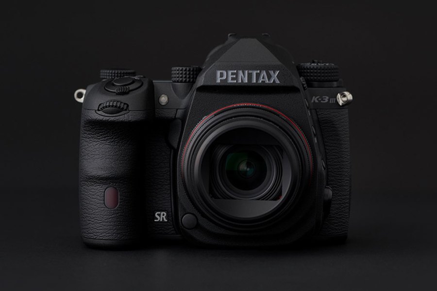 Pentax K-3 III Monochrome against a black background front view, Pentax monochrome DSLR for black and white photography video