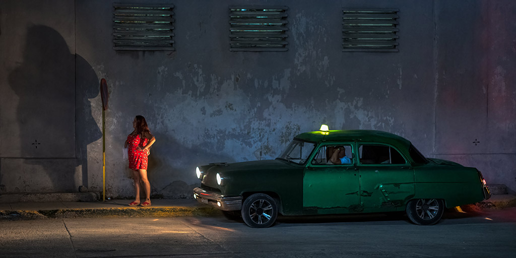 Havana Nights woman standing by taxy at night