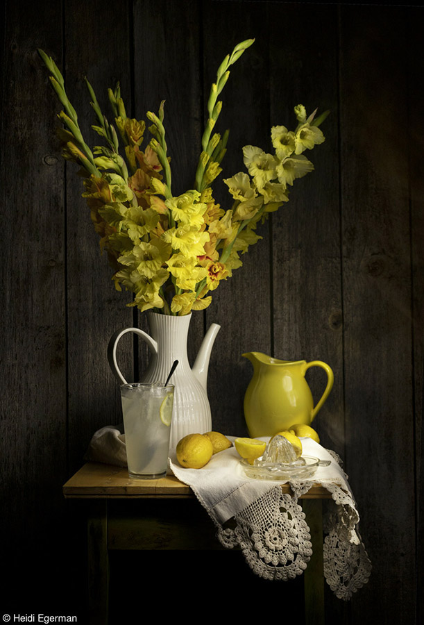 still life of white jug with lemons and yellow gladioli