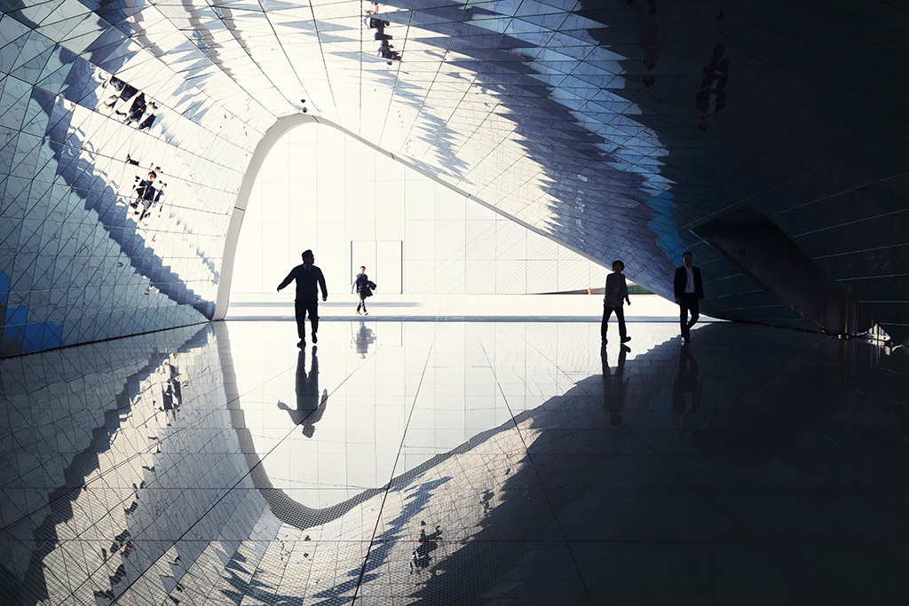 people inside curved building with reflections The Imprint, by MVRDV. Seoul, South Korea