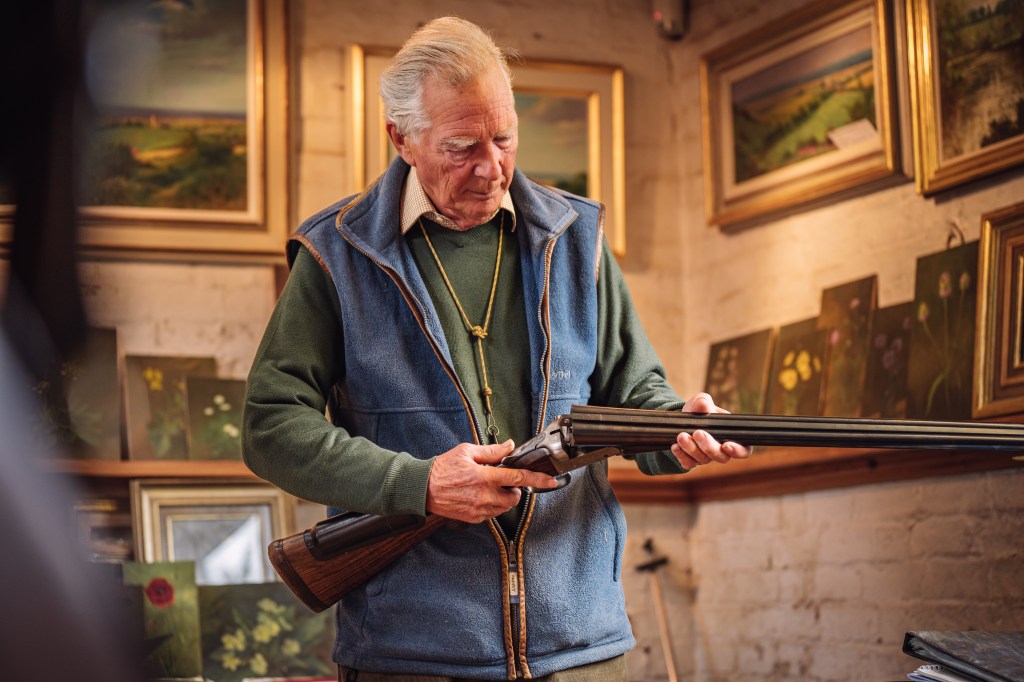 portrait of a man with rifle, in the background still life and landscape paintings. Sony A7 IV test