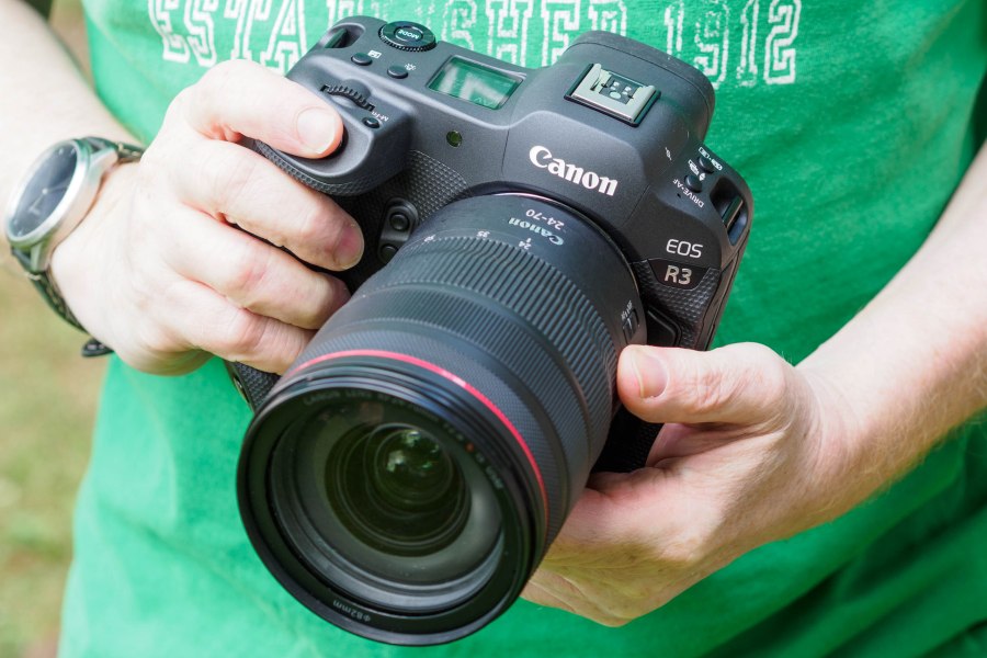 Canon EOS R3 mirrorless camera in hands.