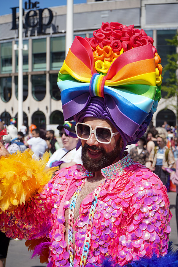 Man at birmingham pride wearing large rainbow bow