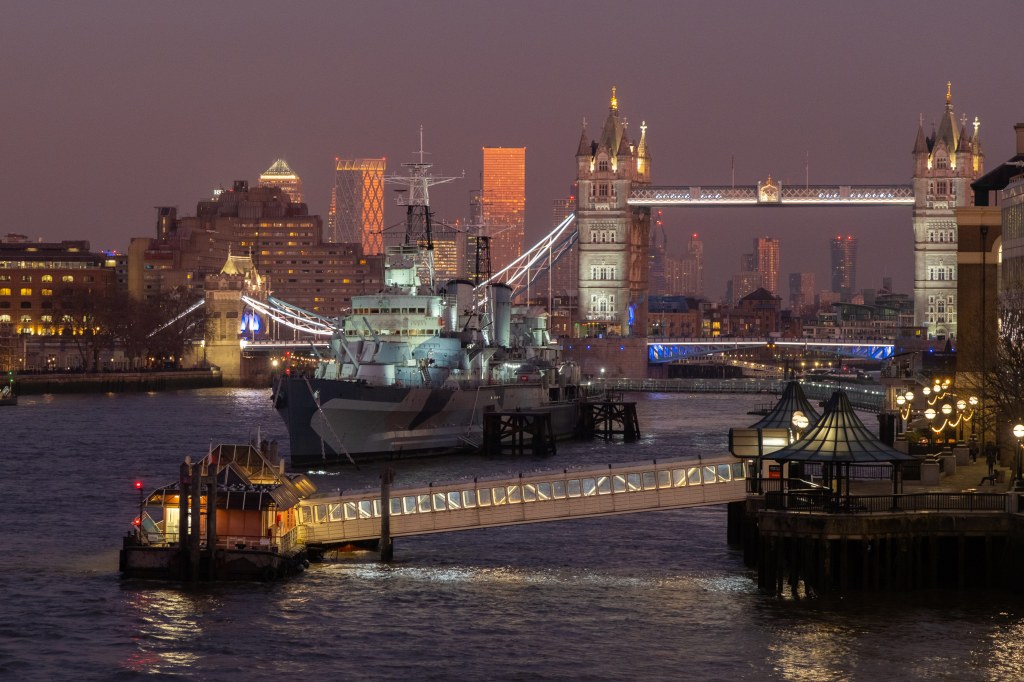 The Tower Bridge and The HMS Belfast in London after sunset