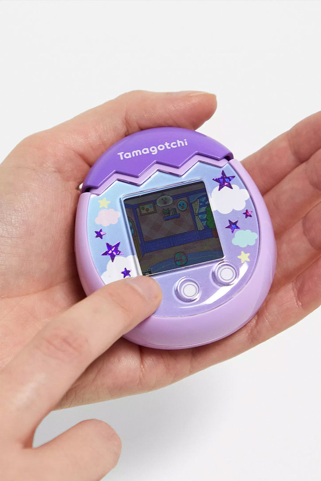 Purple Tamagotchi Pix in hand, Urban Outfitters
