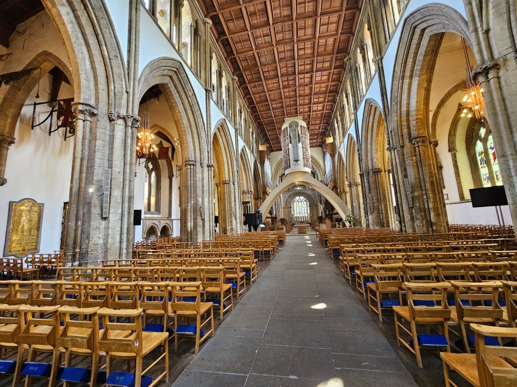 Sample photo taken with Samsung S23. Church interior with wooden chairs and blue cushions