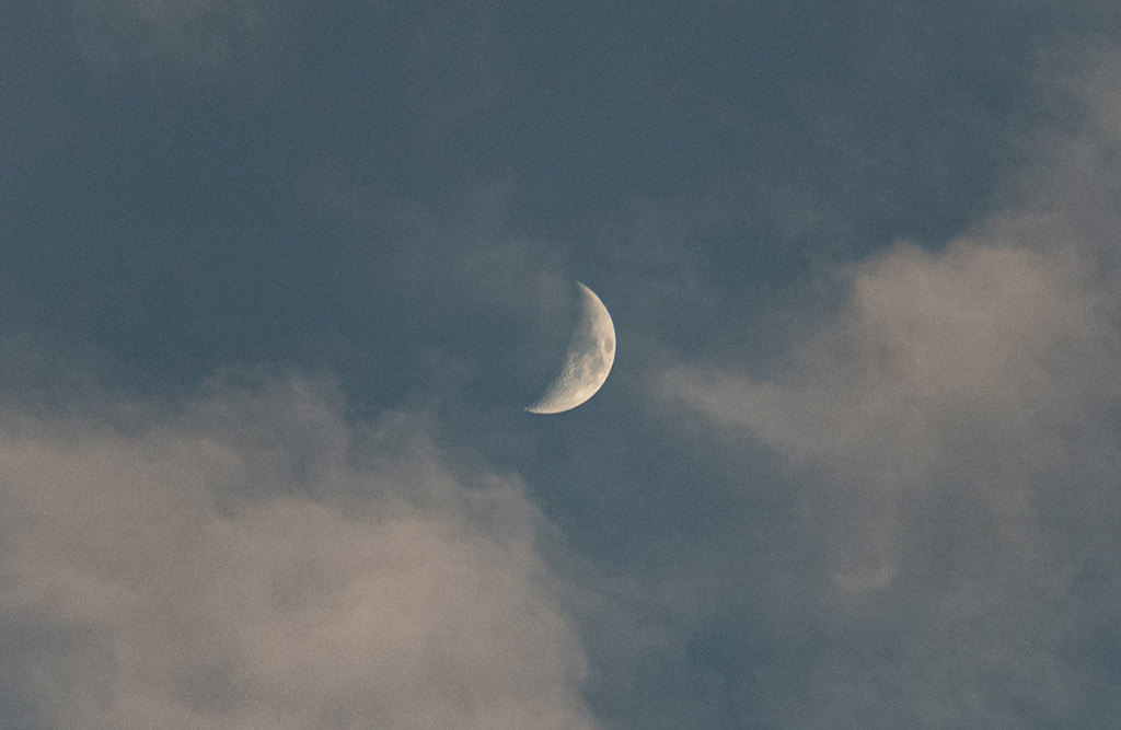 waxing moon surrounded by light cloud taken using a samsung galaxy s9