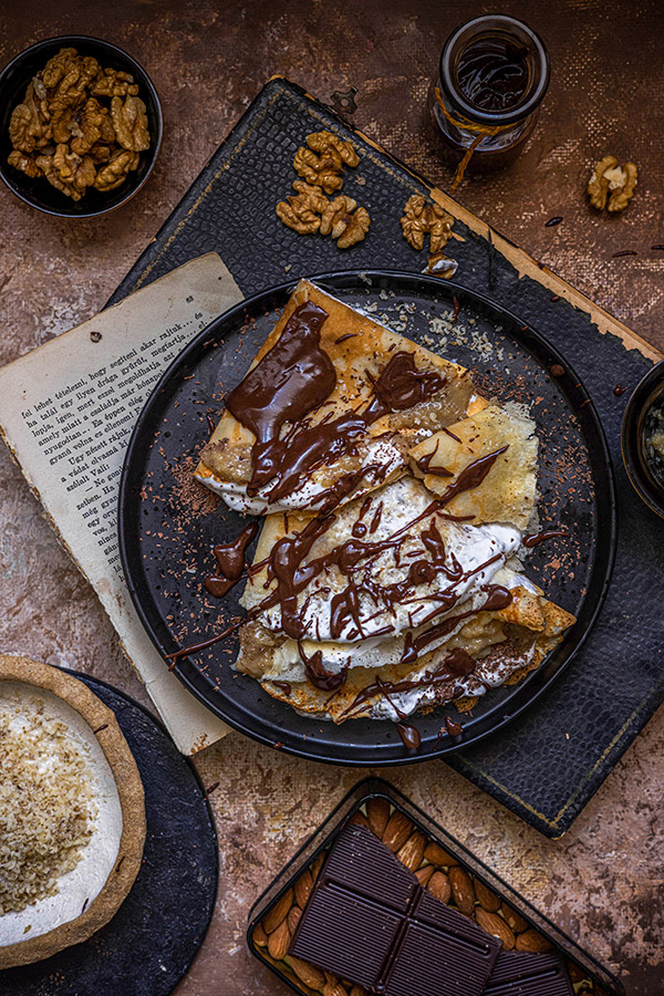 food photography still life with folded crepe pancakes and chocolate sauce