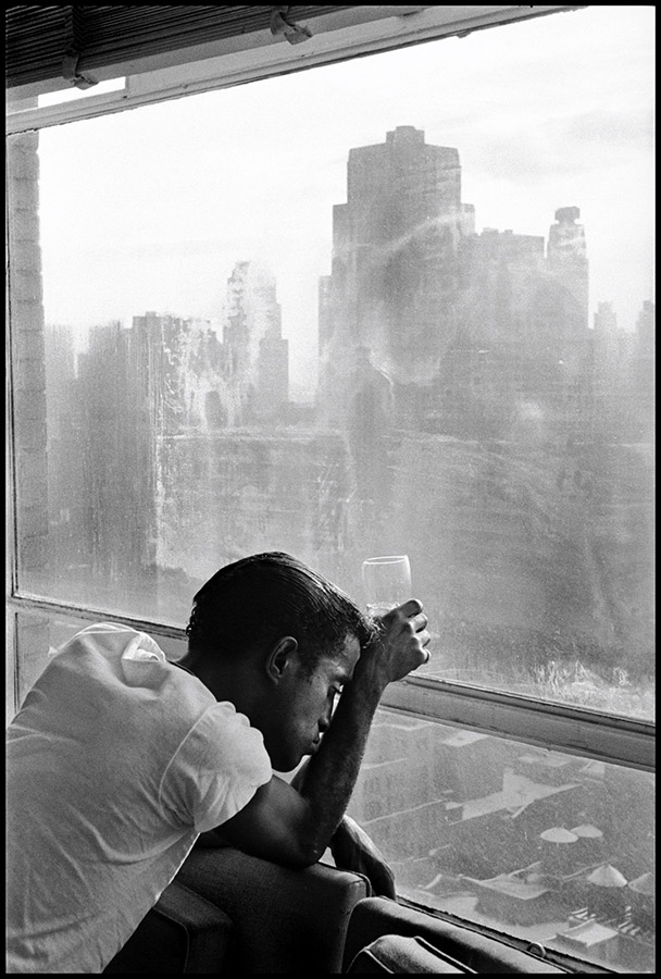Sammy Davis Jr. looks out a Manhattan window. New York City, USA, 1959. © Burt Glinn / Magnum 