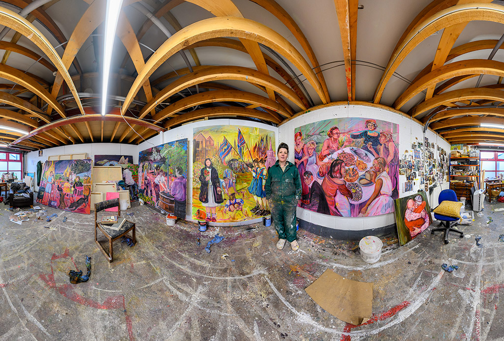 Artist stood with large scale paintings in 360 degree full view of studio