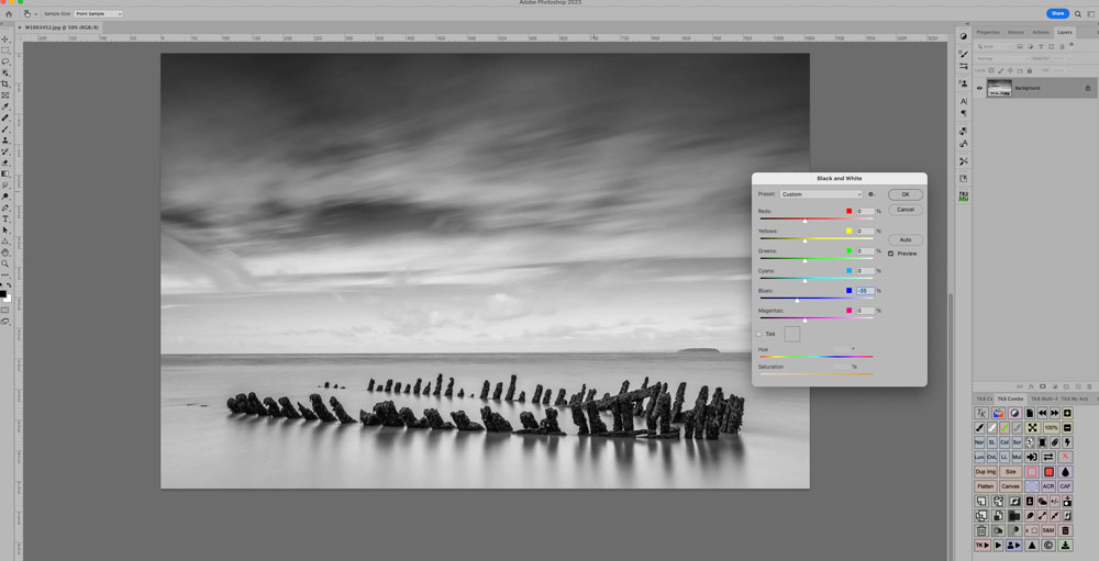 Photoshop black and white editing panel, the image displayed is a black and white photo of an old wooden shipwreck sticking out from the sand in Nornen beach near Burnham-on-Sea in Somerset. 