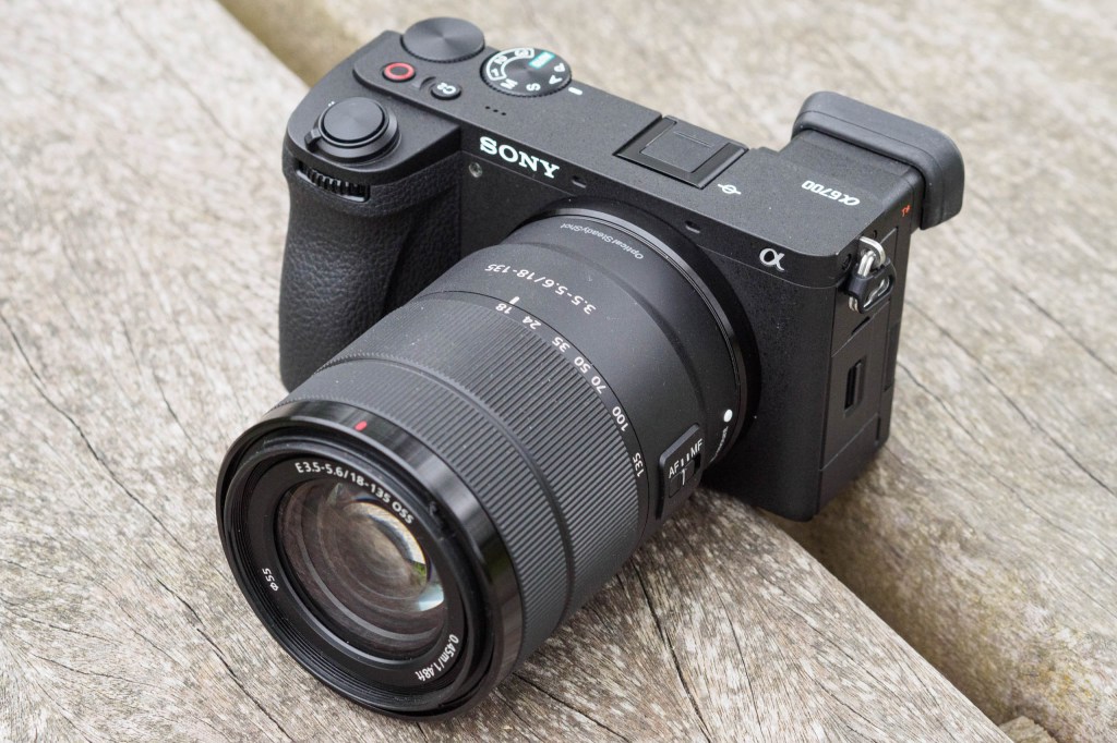 Sony Alpha A6700 with 18-135mm zoom, on a grey weathered wooden surface