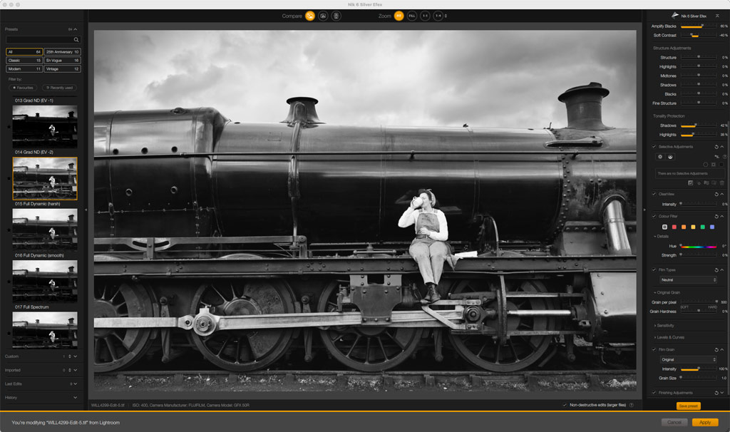 Woman drinking from a tea cup sitting on the side of a steam train. Nik Collection 6 Silver Efex plugin in Photoshop 