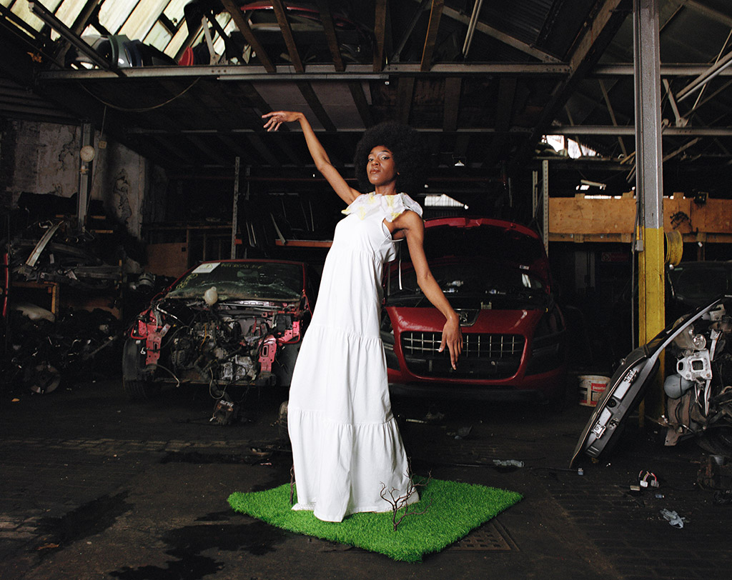 woman in white stood on a patch of artificial grass