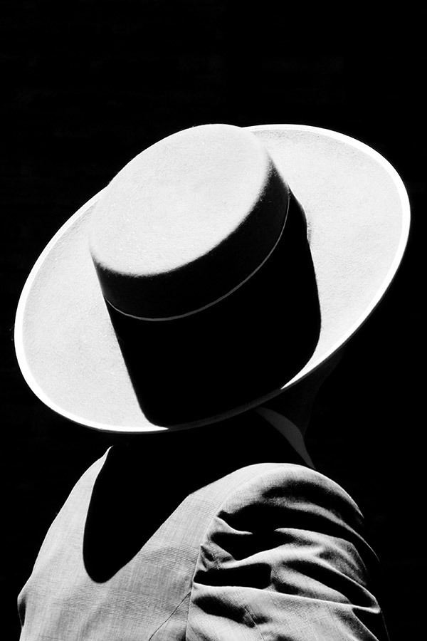 strong summer light on person wearing trilby abstract photo