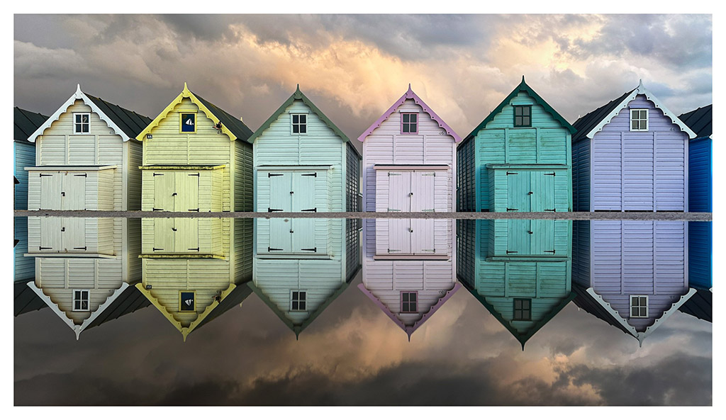 shaun mills iphone 14 pro beach huts reflection in water