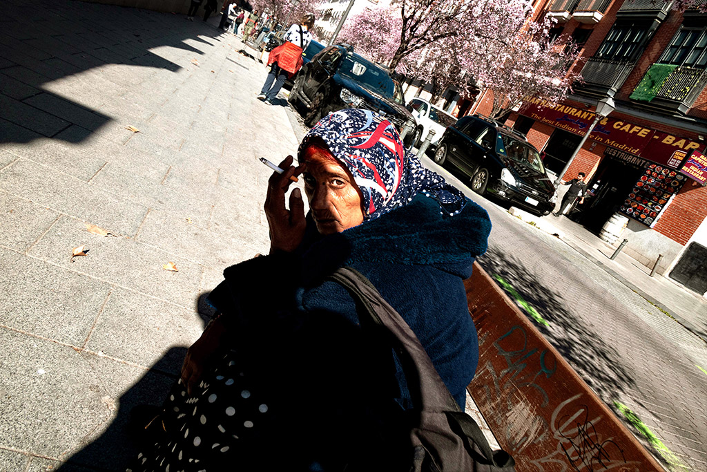 woman in bright sunlight with hand over face