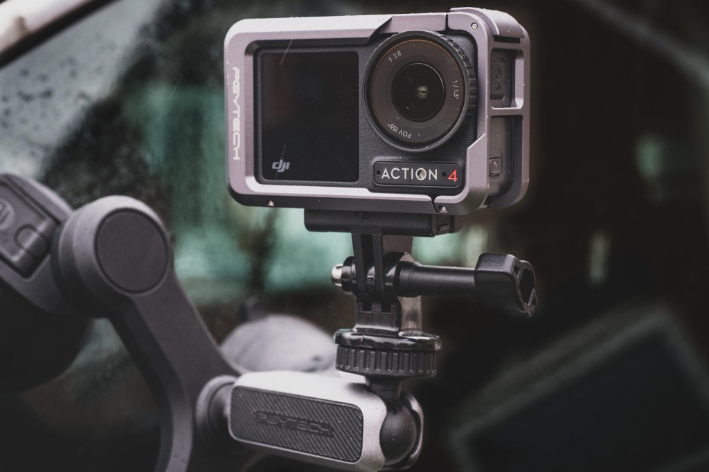 DJI Osmo Action4 action camera attached to a cars windscreen. Matty Graham