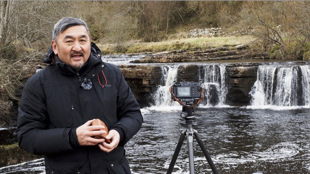 Will Cheung in front of camera shooting a video