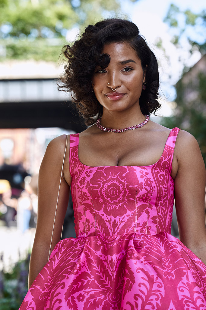 Indya Moore at Carolina Herrera street style at fashion week bright pink dress