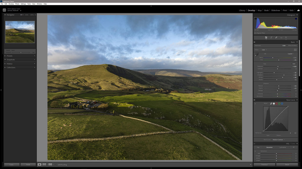 Aerial photography-the setting sun casts strong shadows on a landscape with green fields and hills