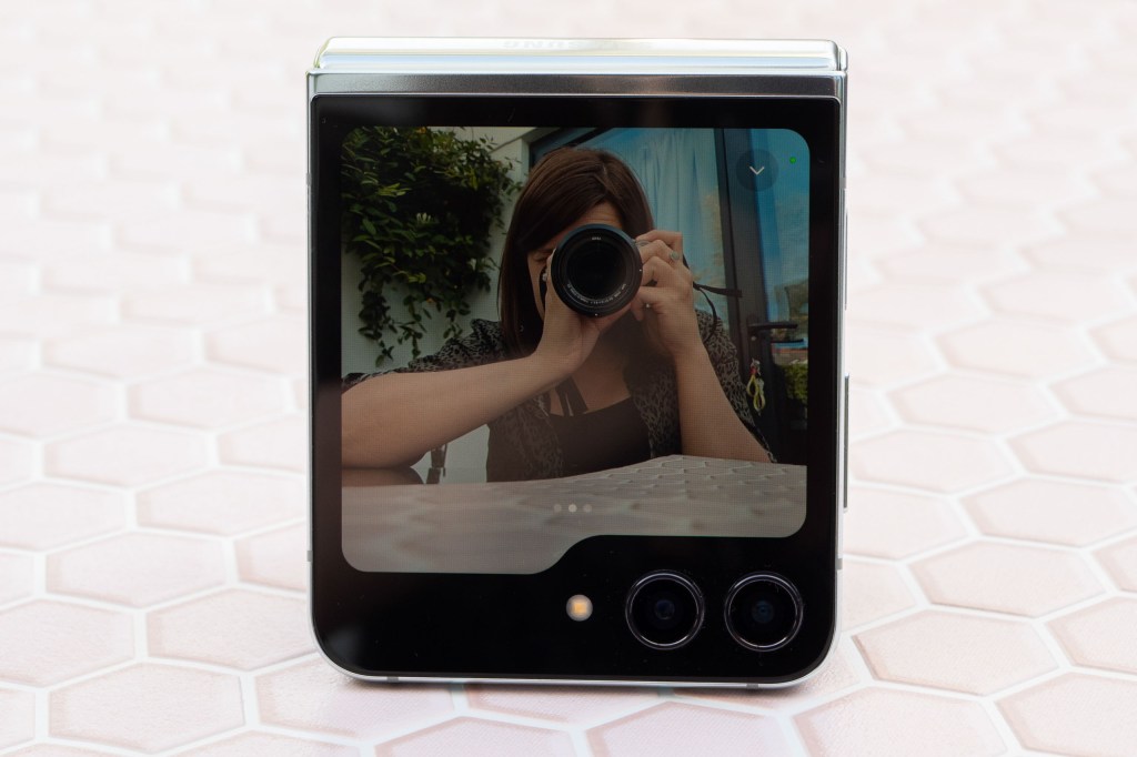 Samsung Galaxy Z Flip 5 Sample image, folded dispalying an image of a woman with a camera in front of her eye
