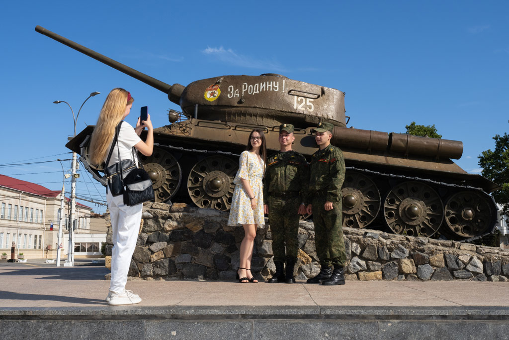 A woman poses for photographs with soldiers on Republisc Day in Tiraspol
