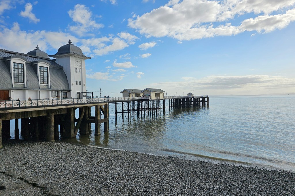 S23 Ultra 1x General camera sample image, white and grey pier and sea, blue skies with a few white clouds