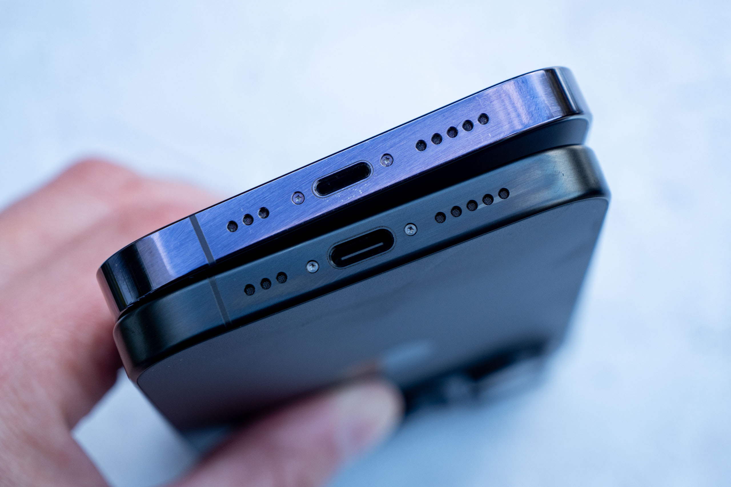 The iPhone 15 Pro – seen at the bottom here – has a USB-C charging socket, rather than a Lightning socket. 