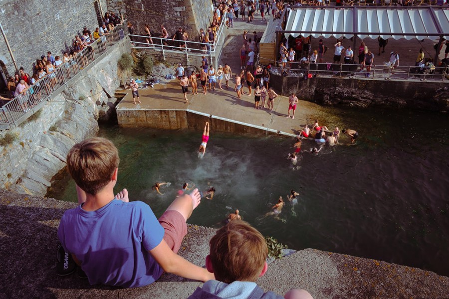 people jumping into water in plymouth