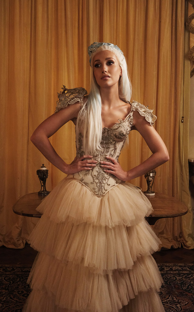 model emma-rose collingridge stood in gold coloured room in princess gown
