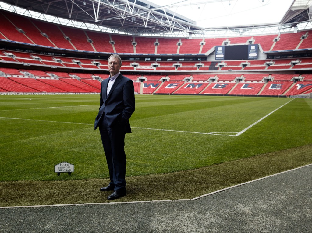 Sir Geoff Hurst standing on a football pitch