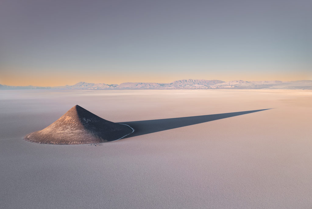 a solitary dune casts a long shadow on the barren landscape, International Landscape Photographer of the Year 2023 competition 