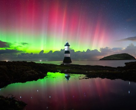 Northern lights in Welsh seaside with a lighthouse KAT LAWMAN