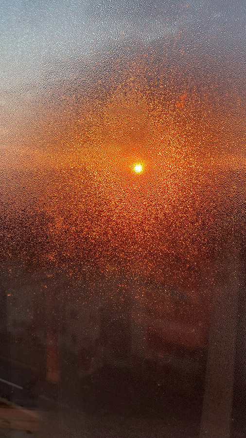 abstract sunset photo taken through condensation window