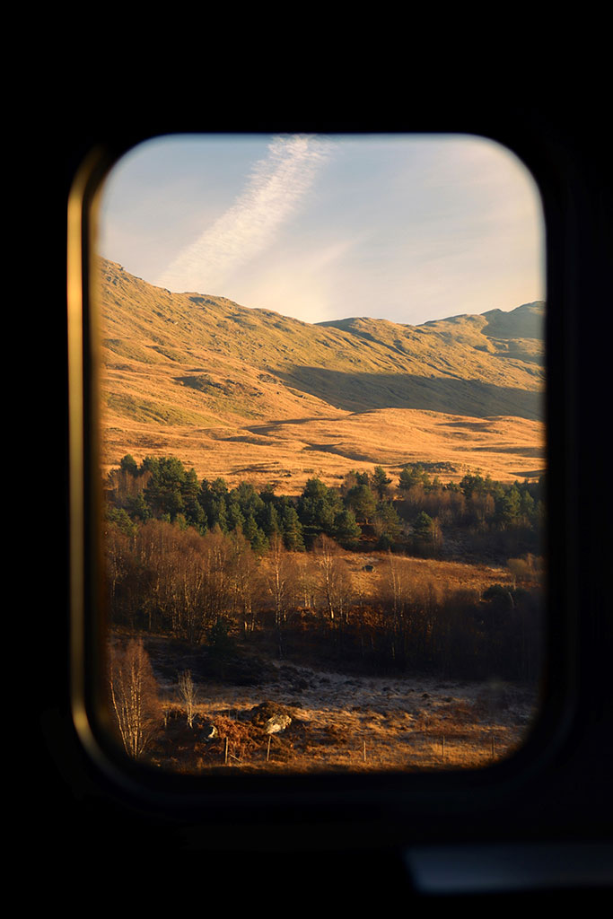 golden hour hills through a train window