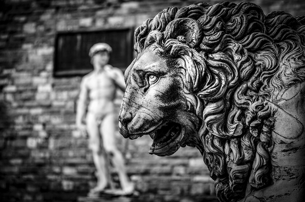 Leica M11 sample image: Black and white image of a lions head statue, in the background a David Statue