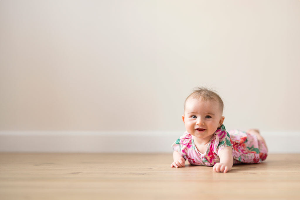 Photoshop artificial intelligence Generative expand tool example, a baby crawling on the floor. landscape orientation image expanded background