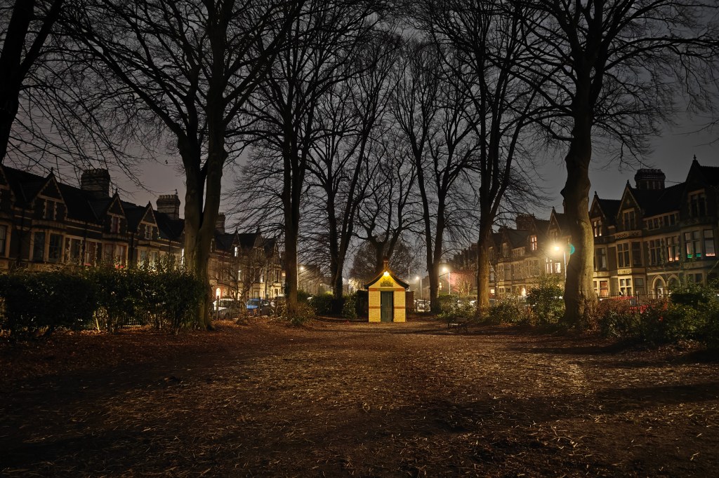 One Plus 12 sample image, night mode, a small brick shed in a park