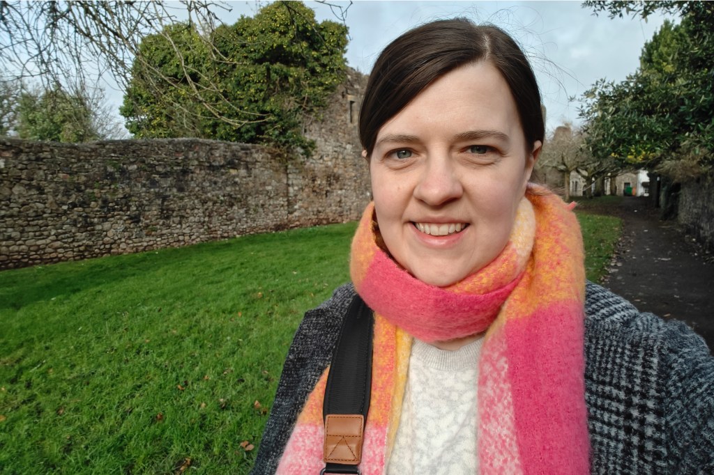 One Plus 12 sample image, selfie camera, portrait of a woman wearing a colourful orange and pink scarf