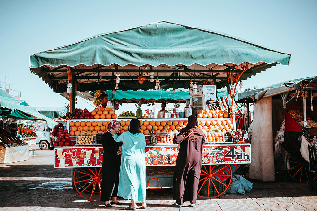 people buying fruit from street vendor