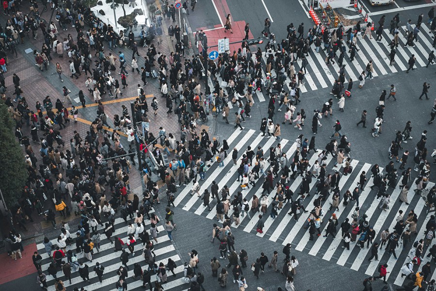 taken from above very busy crossing as hundred of people cross the road