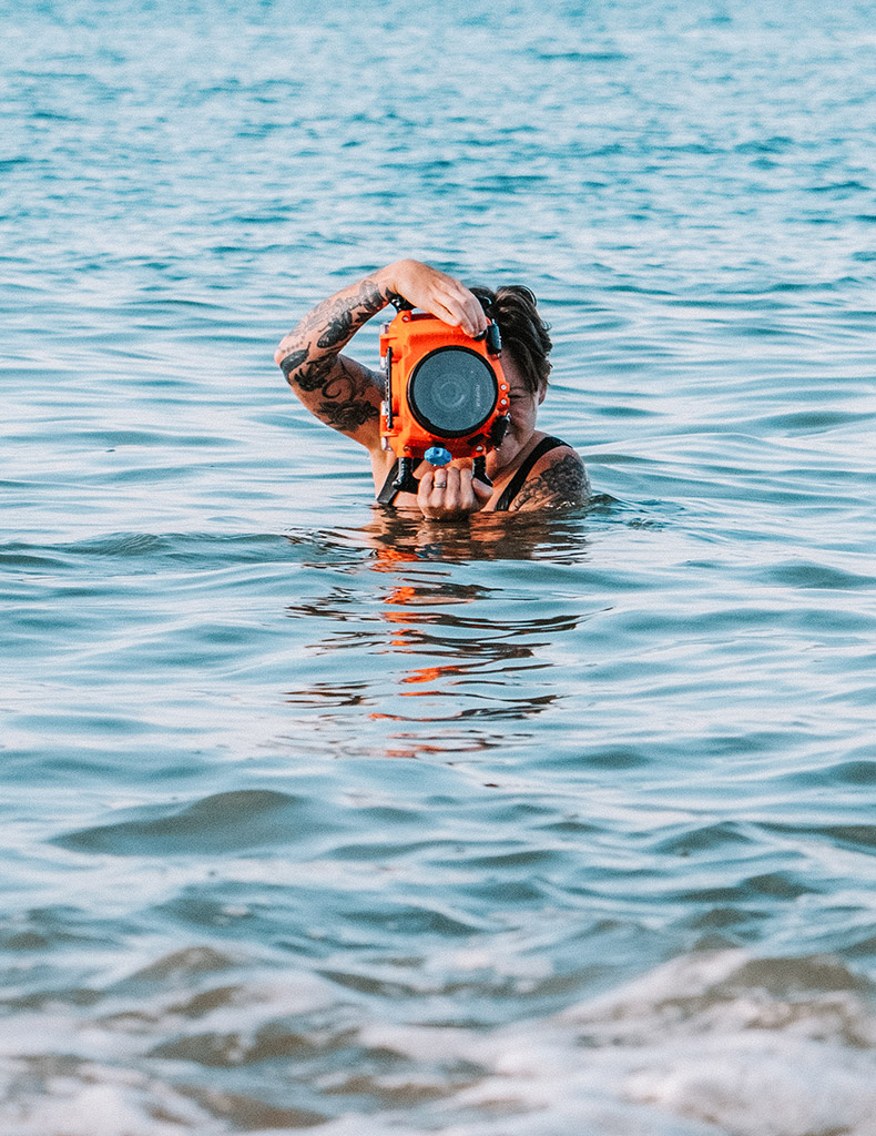 Emily out in the ocean with her underwater set-up of the Fujifilm X-T5 and AquaTech Edge Pro underwater housing