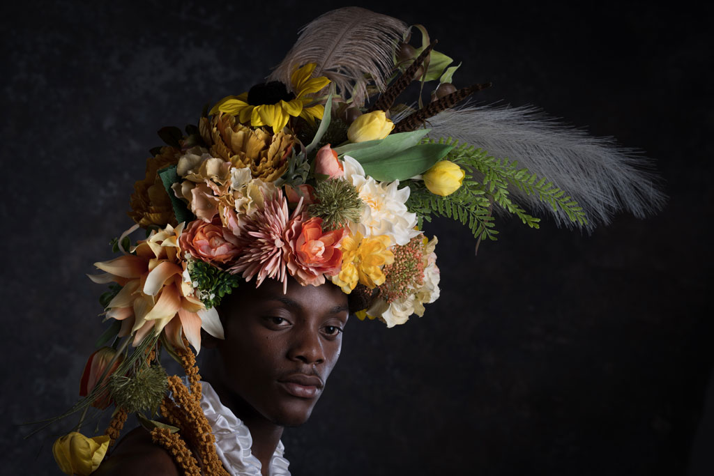 Nikon Z8 Sample image, studio portrait of a man against a black backgroundwith flowers on his head