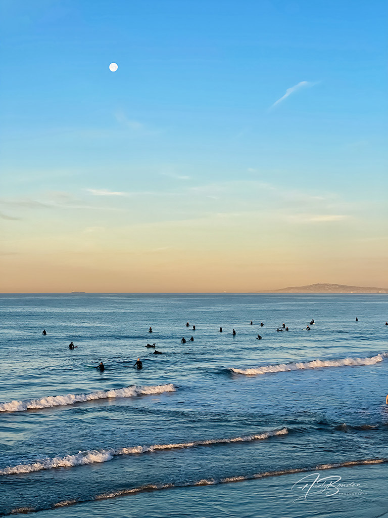 Newport Pier in Newport Beach, California.  It was the setting of the first just past full moon of the year under clear skies