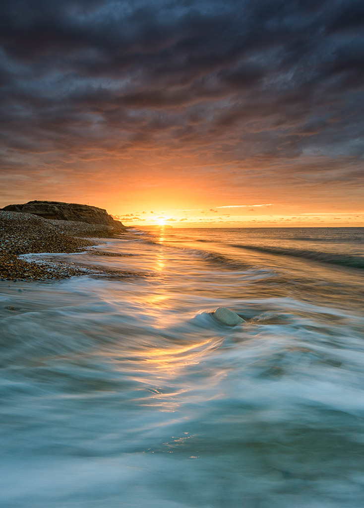 Hengistbury Head, Dorset. The early morning sky comes alive with bright colour as a stark contrast to the angry, dark clouds above; the light and dark converging just for a moment Nikon D7200, 10-20mm, 0.8sec at f/11, ISO 100