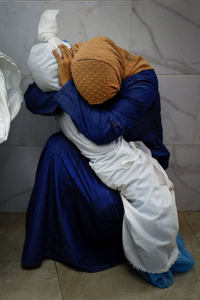 A woman cradles the body of her niece who was killed, along with four other family members, when an Israeli missile struck their home. World Press Photo 2024 regional winner