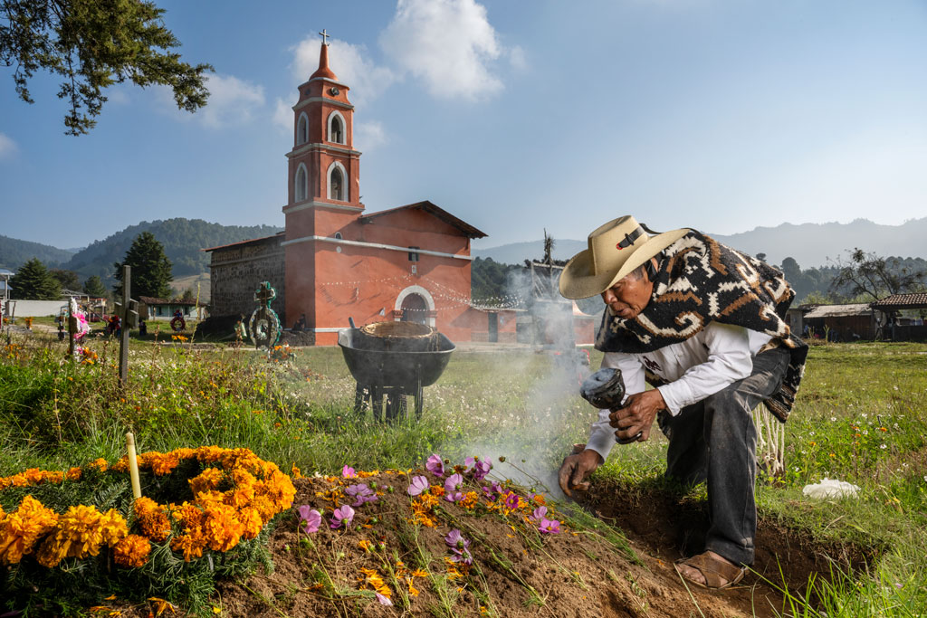 A man decorates the graves of relatives to celebrate the Day of the Dead. World Press Photo 2024 regional winners